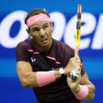 
              Rafael Nadal, of Spain, wearing a bandage on his nose, returns a shot to Fabio Fognini, of Italy, during the second round of the U.S. Open tennis championships, Friday, Sept. 2, 2022, in New York. (AP Photo/Frank Franklin II)
            