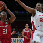 
              Canada's Nirra Fields shoots for goal as Japan's Monica Okoye attempts to block during their game at the women's Basketball World Cup in Sydney, Australia, Sunday, Sept. 25, 2022. (AP Photo/Mark Baker)
            