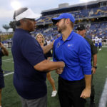 
              Memphis head coach Ryan Silverfield, center right, shakes hands with Navy head coach Ken Niumatalolo, center left, after an NCAA college football game, Saturday, Sept. 10, 2022, in Annapolis, Md. (AP Photo/Nick Wass)
            