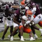 
              Sam Houston State wide receiver Noah Smith, center, is wrapped up by Texas A&M linebacker Chris Russell Jr. (24) and defensive back Demani Richardson (26) during the second half of an NCAA college football game Saturday, Sept. 3, 2022, in College Station, Texas. (AP Photo/David J. Phillip)
            