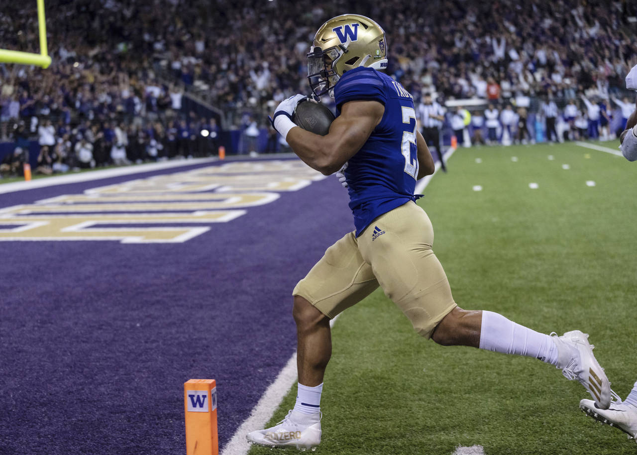 Washington running back Wayne Taulapapa scores a touchdown against Stanford during the first half o...