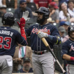 
              Atlanta Braves' Michael Harris II, left, is congratulated by Marcell Ozuna after hitting a solo home run off Seattle Mariners relief pitcher Erik Swanson during the eighth inning of a baseball game, Sunday, Sept. 11, 2022, in Seattle. (AP Photo/Stephen Brashear)
            