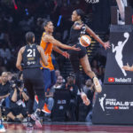 
              Connecticut Sun forward DeWanna Bonner, third from left, gets off a pass to teammate Brionna Jones, right, as Las Vegas Aces forward A'ja Wilson (22) attempts to block it during the first half in Game 1 of a WNBA basketball final playoff series Sunday, Sept. 11, 2022, in Las Vegas. (AP Photo/L.E. Baskow)
            