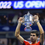 
              Carlos Alcaraz, of Spain, holds up the championship trophy after defeating Casper Ruud, of Norway, in the men's singles final of the U.S. Open tennis championships, Sunday, Sept. 11, 2022, in New York. (AP Photo/Matt Rourke)
            