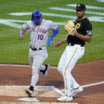 
              New York Mets' Eduardo Escobar (10) scores on a wild pitch by Pittsburgh Pirates starting pitcher Johan Oviedo, right, during the second inning of the second baseball game of a doubleheader in Pittsburgh, Wednesday, Sept. 7, 2022. (AP Photo/Gene J. Puskar)
            