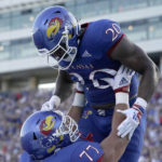 
              Kansas running back Daniel Hishaw Jr. (20) celebrates with offensive lineman Bryce Cabeldue (77) after scoring a touchdown during the first half of an NCAA college football game against Tennessee Tech Friday, Sept. 2, 2022, in Lawrence, Kan. (AP Photo/Charlie Riedel)
            