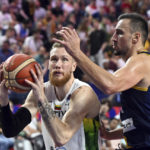 
              Lithuania's Ignas Brazdeikis, left, is challenged by Bosnia-Herzegovina's Edin Atic, right, during their Eurobasket group B basketball match in Cologne, Germany, Wednesday, Sept. 7, 2022. (Federico Gambarini/dpa via AP)
            
