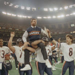 
              FILE - Chicago Bears head coach Mike Ditka is carried off the field by Steve McMichael, left, and William Perry after the team won Super Bowl XX against the New England Patriots in New Orleans on Jan. 26, 1986. A poll by The Associated Press and the NORC Center for Public Affairs Research conducted Sept. 9-12, 2022, finds that about 3 in 10 Americans say they feel God plays a role in determining which team goes home the victor. (AP Photo/Phil Sandlin, File)
            