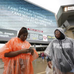 
              Diamond King, left, and Nykala Johnson wait for play to resume during a weather delay for an NCAA college football game between Sam Houston State and Texas A&M Saturday, Sept. 3, 2022, in College Station, Texas. (AP Photo/David J. Phillip)
            