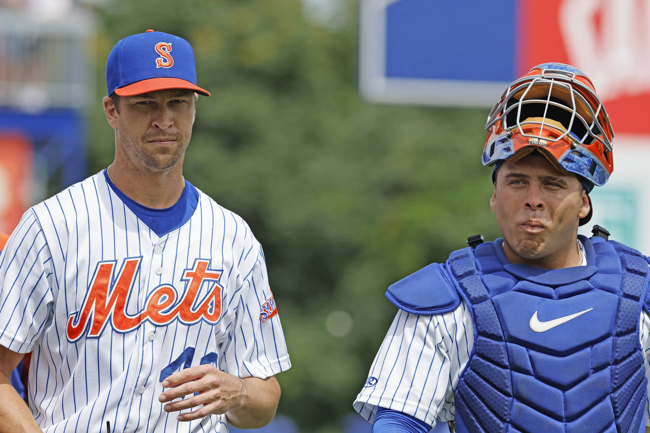 FILE - New York Mets' Jacob deGrom walks onto the field with catcher Francisco Álvarez to pitch fo...