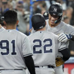 
              New York Yankees' Aaron Judge, right, is congratulated by teammates, including Harrison Bader (22), for his 61st home run of the season, against the Toronto Blue Jays during the seventh inning of a baseball game Wednesday, Sept. 28, 2022, in Toronto. (Nathan Denette/The Canadian Press via AP)
            