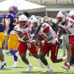 
              North Carolina State's Sean Brown (20) celebrates his recovery of a blocked punt by teammates Jordan Poole (33) and Rakeim Ashford (16) during the first half of an NCAA college football game against East Carolina in Greenville, N.C., Saturday, Sept. 3, 2022. (AP Photo/Karl B DeBlaker)
            