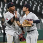 
              Cleveland Guardians' Jose Ramirez, left, and Steven Kwan celebrate the team's 10-7 over the Chicago White Sox in an 11 innings baseball game Tuesday, Sept. 20, 2022, in Chicago. (AP Photo/Charles Rex Arbogast)
            