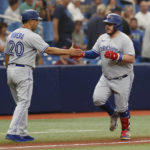 
              Toronto Blue Jays' Alejandro Kirk, right, celebrates with third base coach Luis Rivera after hitting a home run against the Tampa Bay Rays during the second inning of a baseball game Sunday, Sept. 25, 2022, in St. Petersburg, Fla. (AP Photo/Scott Audette)
            