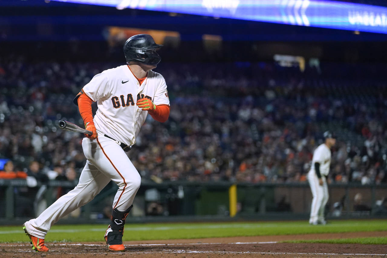 San Francisco Giants' Joc Pederson watches his two-run triple against the Colorado Rockies during t...