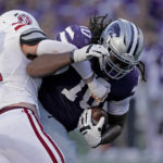 
              Kansas State wide receiver Brenen Hawkins (10) is tackled by South Dakota defensive lineman Nick Gaes (54) after recovering a fumble during the first half of an NCAA college football game Saturday, Sept. 3, 2022, in Manhattan, Kan. (AP Photo/Charlie Riedel)
            