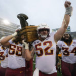 
              Iowa State offensive lineman Trevor Downing (52) celebrates with the Cy-Hawk trophy after an NCAA college football game against Iowa, Saturday, Sept. 10, 2022, in Iowa City, Iowa. Iowa State won 10-7. (AP Photo/Charlie Neibergall)
            