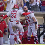 
              St. Louis Cardinals' Brendan Donovan (33) celebrates with teammate Albert Pujols, right, after hitting a grand slam during the seventh inning of a baseball game against the San Diego Padres, Thursday, Sept. 22, 2022, in San Diego. (AP Photo/Gregory Bull)
            