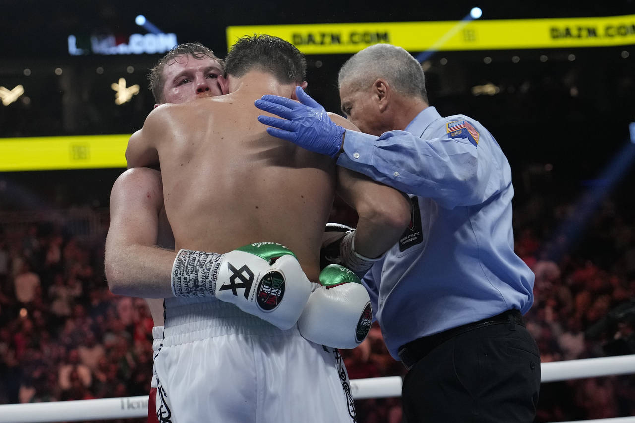 Canelo Alvarez, left, embraces Gennady Golovkin after defeating Golovkin in their super middleweigh...