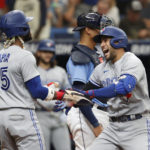 
              Toronto Blue Jays' George Springer, right, celebrates with teammate Ric Tapia after hitting a two-run home run against the Tampa Bay Rays during the third inning of a baseball game Sunday, Sept. 25, 2022, in St. Petersburg, Fla. (AP Photo/Scott Audette)
            
