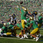 
              Notre Dame safety Brandon Joseph and California wide receiver Mavin Anderson (11) leap for a tipped ball as time expired in the second half of an NCAA college football game in South Bend, Ind., Saturday, Sept. 17, 2022. The pass was incomplete. Notre Dame defeated California 24-17.(AP Photo/Michael Conroy)
            