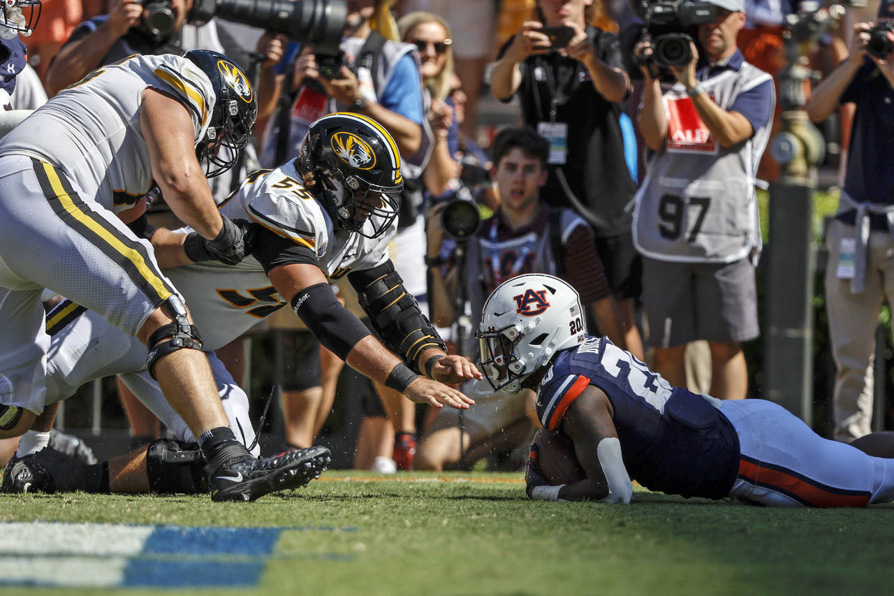 Auburn safety Cayden Bridges (20) recovers a fumble in the end zone to secure the win as Missouri o...