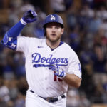 
              Los Angeles Dodgers' Max Muncy gestures as he heads to third after hitting a solo home run during the sixth inning of a baseball game against the San Francisco Giants Tuesday, Sept. 6, 2022, in Los Angeles. (AP Photo/Mark J. Terrill)
            