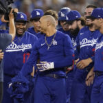 
              Los Angeles Dodgers' Mookie Betts, center, is greeted by teammates after he hit a walk-off single to win a baseball game 3-2 against the Arizona Diamondbacks in Los Angeles, Thursday, Sept. 22, 2022. Freddie Freeman scored. (AP Photo/Ashley Landis)
            