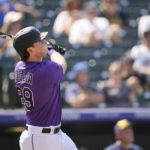 
              Colorado Rockies' Michael Toglia follows the flight of his three-run home run off Milwaukee Brewers starting pitcher Eric Lauer in the third inning of a baseball game Wednesday, Sept. 7, 2022, in Denver. (AP Photo/David Zalubowski)
            