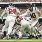 
              Houston Texans quarterback Davis Mills (10) hands off to running back Rex Burkhead (28) during the second half of an NFL football game Sunday, Sept. 11, 2022, in Houston. (AP Photo/Eric Christian Smith)
            