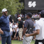 
              Dustin Johnson, left, smiles as he is congratulated by Anirban Lahiri, center, and Joaquin Niemann after winning the LIV Golf Invitational-Boston tournament in a playoff, Sunday, Sept. 4, 2022, in Bolton, Mass. (AP Photo/Mary Schwalm)
            