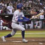 
              Los Angeles Dodgers' Cody Bellinger hits a two-run double in the seventh inning during a baseball game against the Arizona Diamondbacks, Monday, Sept. 12, 2022, in Phoenix. (AP Photo/Rick Scuteri)
            