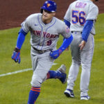 
              New York Mets' Brandon Nimmo (9) rounds third past third base coach Joey Cora after hitting a two-run home run off Pittsburgh Pirates relief pitcher Robert Stephenson during the seventh inning of a baseball game in Pittsburgh, Tuesday, Sept. 6, 2022. (AP Photo/Gene J. Puskar)
            