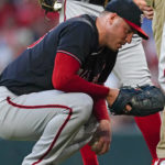 
              Washington Nationals starting pitcher Patrick Corbin (46) waits for the training staff after an injury during the first inning of the team's baseball game against the Atlanta Braves on Tuesday, Sept. 20, 2022, in Atlanta. Corbin left the game. (AP Photo/John Bazemore)
            