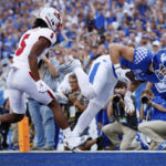 
              Kentucky tight end Brenden Bates, right, falls into the end zone for a touchdown during the first half of the team's NCAA college football game against Miami (Ohio) in Lexington, Ky., Saturday, Sept. 3, 2022. (AP Photo/Michael Clubb)
            