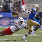 
              UCLA wide receiver Kazmeir Allen, right, runs the ball as Bowling Green safety Chris Bacon attempts a tackle during the second half of an NCAA college football game Saturday, Sept. 3, 2022, in Pasadena, Calif. (AP Photo/Mark J. Terrill)
            