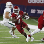 
              Fresno State wide receiver Nikko Remigio runs past Cal Poly defenders for a long gain during the first half of an NCAA college football game in Fresno, Calif., Thursday, Sept. 1, 2022. (AP Photo/Gary Kazanjian)
            