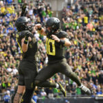 
              Oregon quarterback Bo Nix (10) celebrates a touchdown against BYU with Oregon tight end Terrance Ferguson during the first half of an NCAA college football game, Saturday, Sept. 17, 2022, in Eugene, Ore. (AP Photo/Andy Nelson)
            