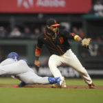 
              Los Angeles Dodgers' Joey Gallo, left, slides into second base after hitting a double next to San Francisco Giants shortstop Brandon Crawford during the second inning of a baseball game in San Francisco, Saturday, Sept. 17, 2022. (AP Photo/Jeff Chiu)
            