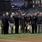 
              Former recipients of the Roberto Clemente Award pose for a photo with Roberto Clemente Jr. and Roberto Clemente III, center, before a baseball game between the Pittsburgh Pirates and the New York Mets on Roberto Clemente Day, Thursday, Sept. 15, 2022, in New York. (AP Photo/Adam Hunger)
            