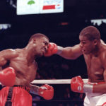 
              FILE - Riddick Bowe, right, delivers a blow to the head of Evander Holyfield during a heavyweight championship fight in Las Vegas, on Nov. 13, 1992. Bowe won by unanimous decision. The two gifted fighters from a rich era of heavyweight contenders met three times over three years. (AP Photo/Doug Pizac, File)
            