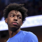 
              FILE - Memphis' James Wiseman watches from the bench during the first half of the team's NCAA college basketball game against Little Rock in Memphis, Tenn., Wednesday, Nov. 20, 2019. The NCAA’s Independent Accountability Resolution Process put Memphis on three years of probation with a public reprimand on Tuesday, Sept. 27, 2022, but declined to punish Tigers coach Penny Hardaway or hand down an NCAA Tournament ban.  The probe began over the recruitment and the short time that James Wiseman spent at Memphis after receiving $11,500 from Hardaway in 2017. (AP Photo/Karen Pulfer Focht, File)
            