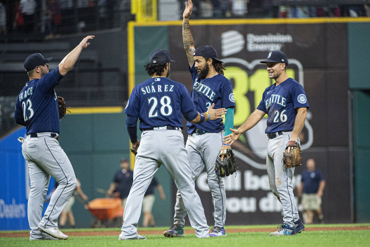 Seattle players Ty France (23), Eugenio Suarez (28), J.P. Crawford (3) and Adam Frazier (26) celebr...