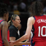 
              United States' coach Cheryl Reeve, center, talks with her players during their semifinal game against Canada at the women's Basketball World Cup in Sydney, Australia, Friday, Sept. 30, 2022. (AP Photo/Rick Rycroft)
            