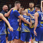 
              Ukraine's players celebrate at the end of the Eurobasket match between Ukraine and Estonia, at the Assago forum near Milan, Italy, Saturday, Sept. 3, 2022. (Claudio Grassi/LaPresse via AP)
            