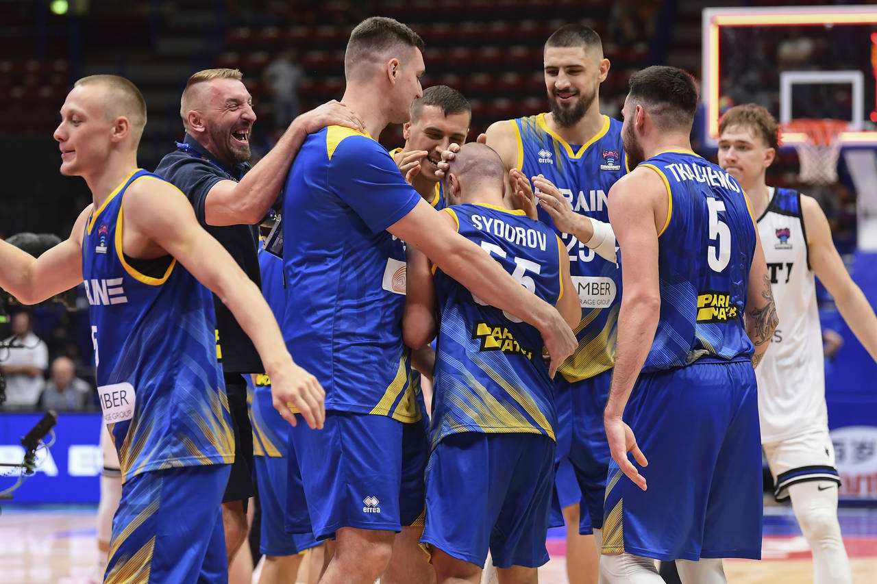 Ukraine's players celebrate at the end of the Eurobasket match between Ukraine and Estonia, at the ...