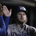 
              Los Angeles Dodgers' Max Muncy is congratulated in the dugout after scoring against the San Francisco Giants during the second inning of a baseball game Friday, Sept. 16, 2022, in San Francisco. (AP Photo/Tony Avelar)
            
