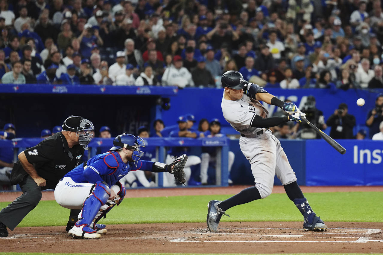 New York Yankees' Aaron Judge (99) flies out, next to Toronto Blue Jays catcher Danny Jansen during...