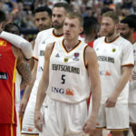 
              Germany's players queue as their teammate Dennis Schroeder hugs Spain's Juancho Hernangomez, left, after the Eurobasket semi final basketball match between Germany and Spain in Berlin, Germany, Friday, Sept. 16, 2022. Spain defeated Germany by 96-91. (AP Photo/Michael Sohn)
            