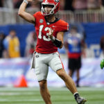 
              Georgia quarterback Stetson Bennett (13) throws on the run in the first half of an NCAA college football game against Oregon Saturday, Sept. 3, 2022, in Atlanta. (AP Photo/John Bazemore)
            